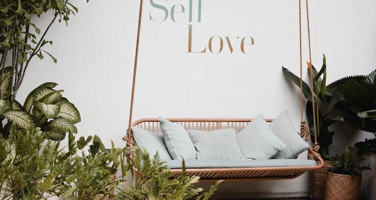brown rattan swing bench with cushions
