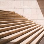 toddler's standing in front of beige concrete stair