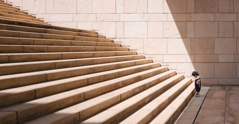 toddler's standing in front of beige concrete stair