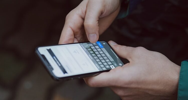 selective focus photography of person using smartphone
